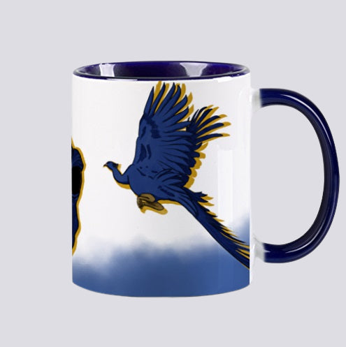 tasse en céramique design par elsa abadie penars avec l'intérieur coloré en bleu. Mug qui passe au lave-vaisselle et au micro ondes. Sur l'extérieur un dessin d'un phœnix bleu, d'un paon curieux qui s'envole 